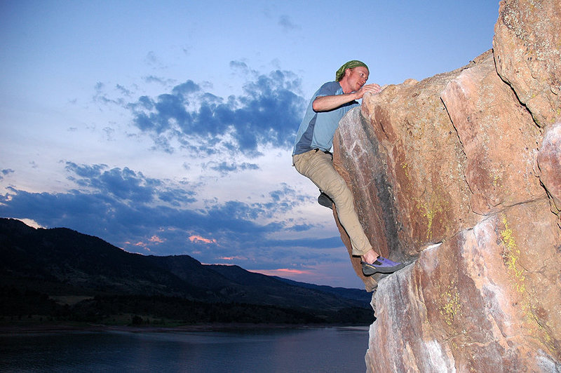 Dylan tops out the Penny Pincher boulder at dusk - the best time to climb Rotary in the summer.