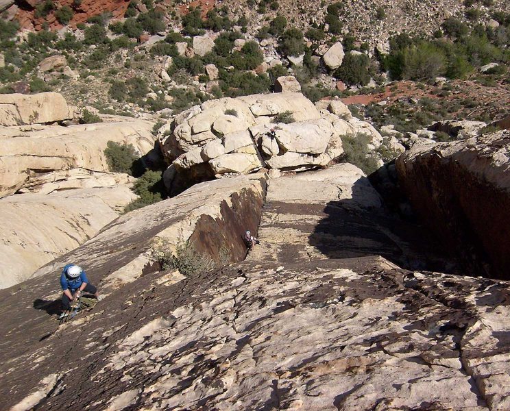 Looking down the varnished corner of pitch 4. The belay at the top of pitch 4 is on the left. This picture was taken from near the beginning of the fifth pitch, above the large overhang.