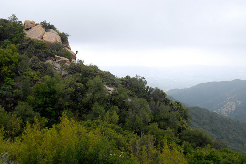 A climber hangs off the top of T-Crack, at Gibraltar Rock, as he belays his second.