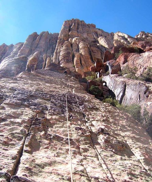 Looking up on the upper rib. The foreshortened exit corner is visible immediately to the right of the belayer.