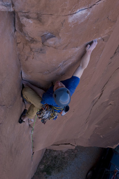 Adam Perks working through a crux on The Flakes of Wrath (5.9+). This is also where the new variation "East of Wrath" moves to the face and continues straight up on horizontal cracks to the new anchor.