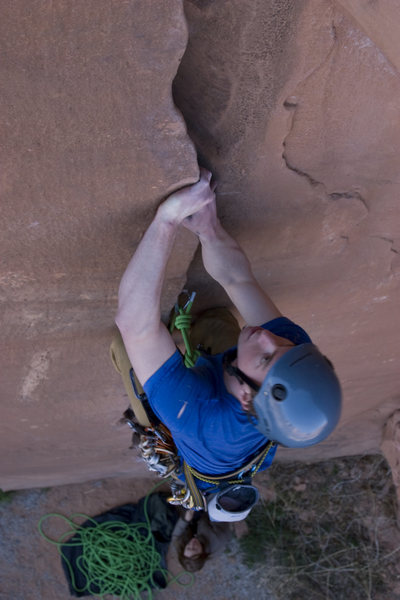 Adam Perks approaching the end of the opening hand/foot jamming moves on Flakes of Wrath (5.9+), Mim in the background with an attentive belay.
