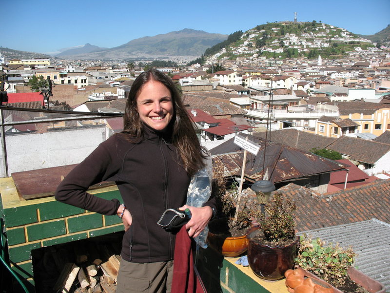 Nancy Bell on the roof of the Secret Garden hostal in Quito. Corazon, near the Illinizas and Cotopaxi, can be seen above her right shoulder, showing Quito's relative proximity to some of Ecuador's most popular peaks.