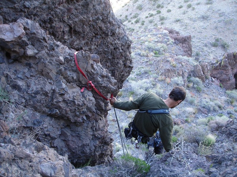 It's downclimb 30 feet of steep, chossy rock, or rap from this anchor. We rapped, as we brought along a 60 foot rope, and some gear, not knowing beforehand what to really expect as far as the "climbing section" to the summit.<br>
<br>
We scampered up this section in hiking boots (maybe one or two moves of 5.5 or 5.6 on chossy rock, then scrambled to the summit. A fun little route! The hike to Castle Peaks, and the summit was beautiful; it was all good!<br>
<br>
Mojave preserve; 4/30/08