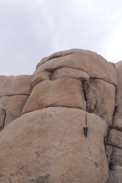 Kevin Newell lookin' positive above the last bolt. You can see a party heading up the Bat Crack on his right.