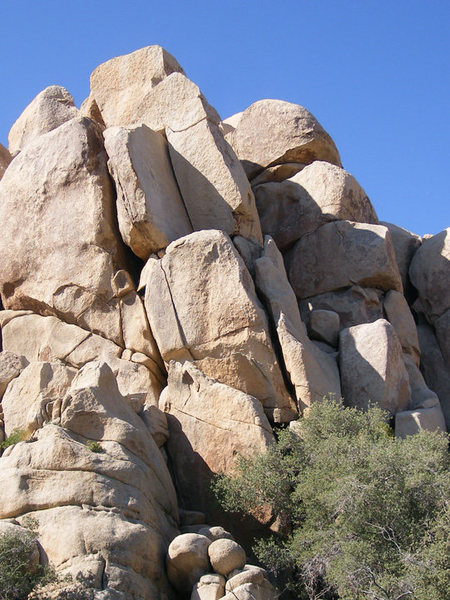 Solo. Climbs the finger crack splitting the lower tier and continues on the wide crack in the upper dihedral.