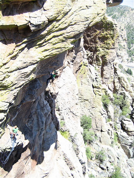Vince Bates belays as Josie Becker pulls the moves leading to the crux. Check out the exposure.