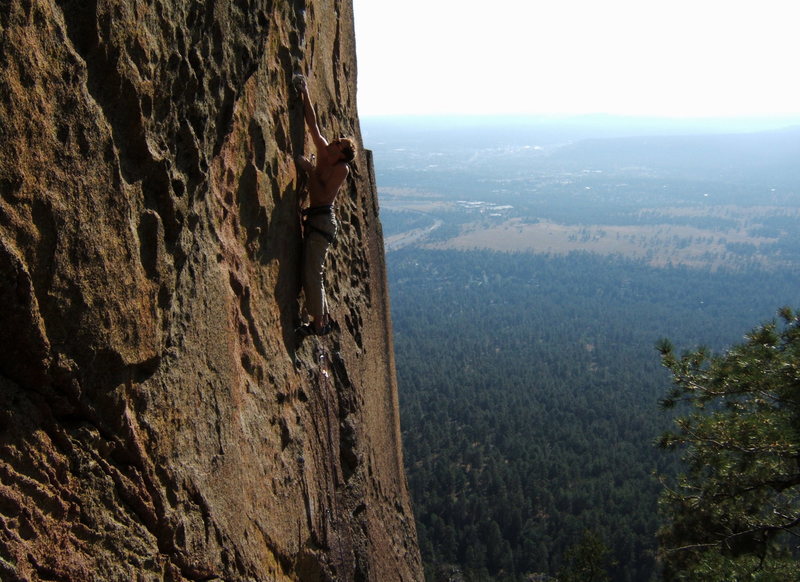 I handed Sam the F.A. attempt. He took it graciously, cruising the first crux shown here. But the thin, balancy arete finish was just awkward enough to make the chains look like a thank God hold. This story merely demonstrates that a complete ascent requires topping out. Hello Flagstaff!!!! Yeah...that's Buffalo Park down there.