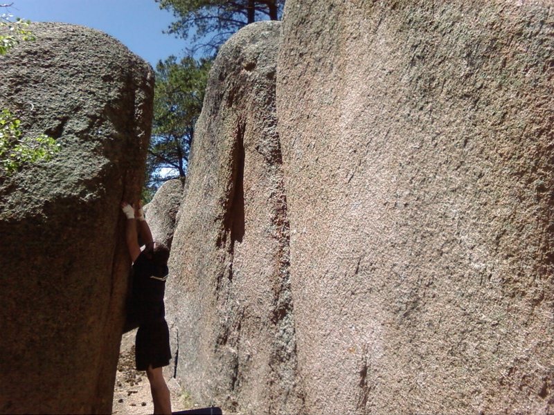 Joe Williams looking for the start on ARETE climb. V4, Gargoyle Boulder. Behind him is Corridor Rock.