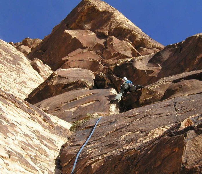 The right-hand variation on pitch 2 goes directly up these cracks. The slanting pitch 3 crack can just barely be seen on the white wall to the upper left.