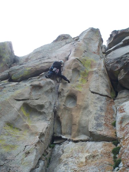 Fun steep climbing leads to a thin crack on the upper face...