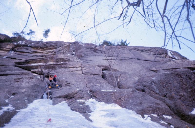 Toe Crack/Standard Route: Cathedral Ledge January 1975<br>
<br>
Ice is nice; verglas isn't. Doug Fosdick and I each had a go at leading the ice-choked crack to the right of the tree but the verglas was too thin for crampons and the rock was too icy for vibram. We bailed after several attempts and returned to North Conway in disgrace.