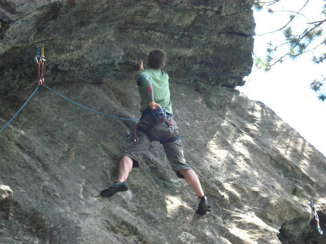 Me, on the only good hold on the upper crux which happens to be a crimp/pinch on a roof but due to the slab feet under you it gives a little rest...