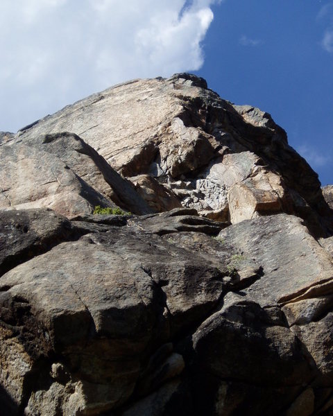Plaque Right climbs through the A-shaped overhang just above center of the photo and then angles right and up to the top along the rounded arête.