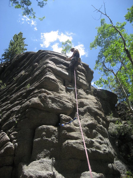 C. Love reaches for a cam on her 1st traditional lead climb.