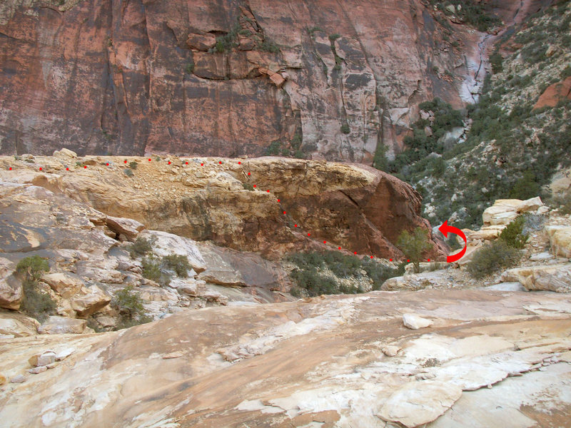 At the bottom of the wilson slabs this red buttress comes into view on the left side of the gulley. Take the slanting step/chimney down into the main drainage in first creek.