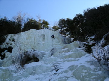 Climber completing the entire route. Most just climb the extreme left side of the pillar to a rap station since the climbing above the pillar is not as challenging.