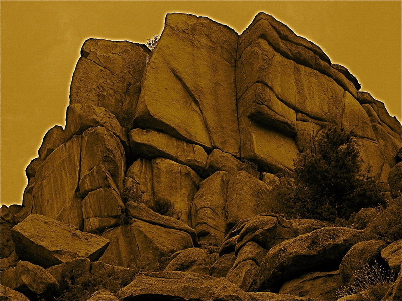 The Bullet Review Rock.<br>
The Bullet Review climbs the classic dihedral. Gunsmoke starts at the bottom left, goes up the right angling crack, jogs left at the horizontal and then up a thin crack just to the left of the leftmost arete.