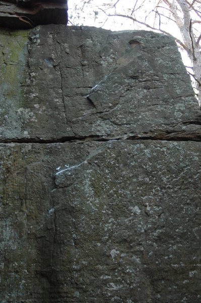 Climb up the face using good edges and the break in the rock