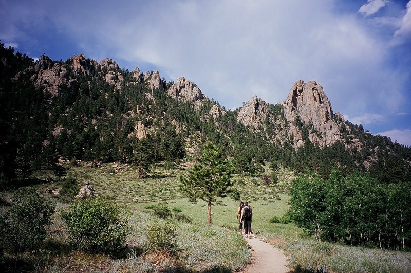 A few unknown climbers descend the trails at Lumpy Ridge in Estes Park, Colorado on a summer afternoon.