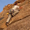 Negotiating the upper bulges, en route to the roof.<br>
<br>
Photo by John Hoffman