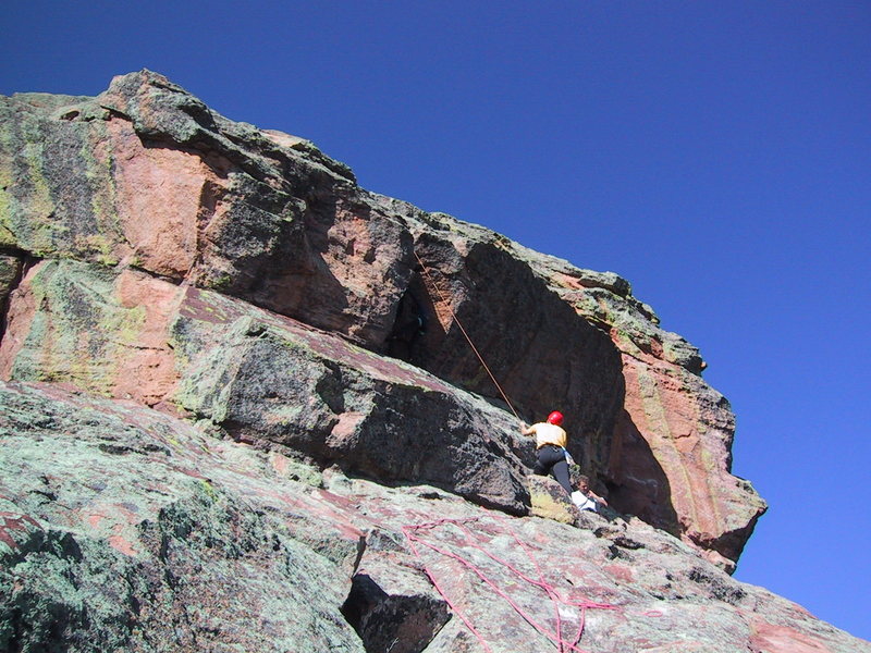 The line of the rope shows the route. Lori is at the crux but very hard to see in the shade. John is belaying at the "Devil's Thumbnail".