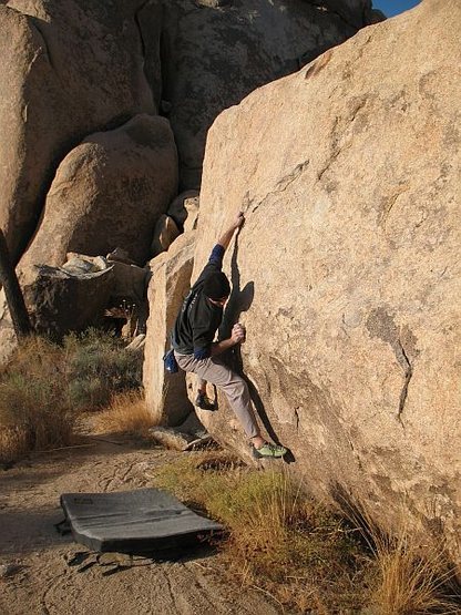 Cranking the reachy start on Ultraviolet (V2), Joshua Tree NP