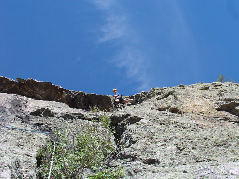 Amy leading in the gully on P2 of Juniper Direct with the Juniper Overhang roof visible to her left (Oct. 1, 2005).