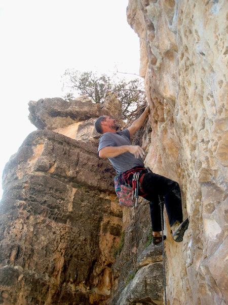 First ascent of Bluto Tastes An Olive. Erik Wolfe climbing