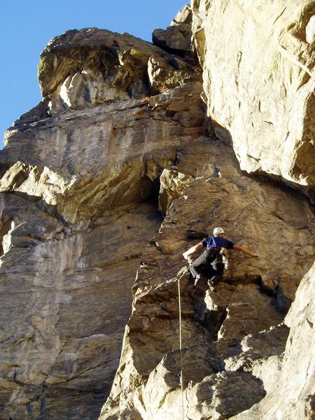On the steep flakes. The awkward-to-reach anchors are at the lip of the roof at the top of the left-facing corner to Ken's left.