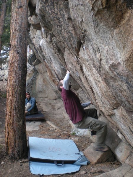 Ian tries a problem in the middle of Energy Crag. Fun moves with a tree right behind you.