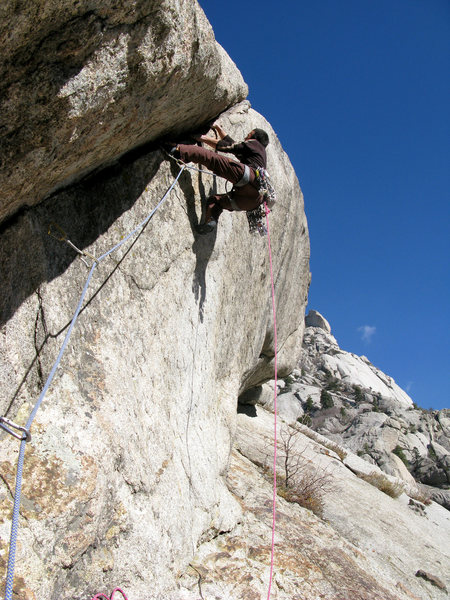 Lance climbing the 5.11d bulge pitch of the Lateral Fin.