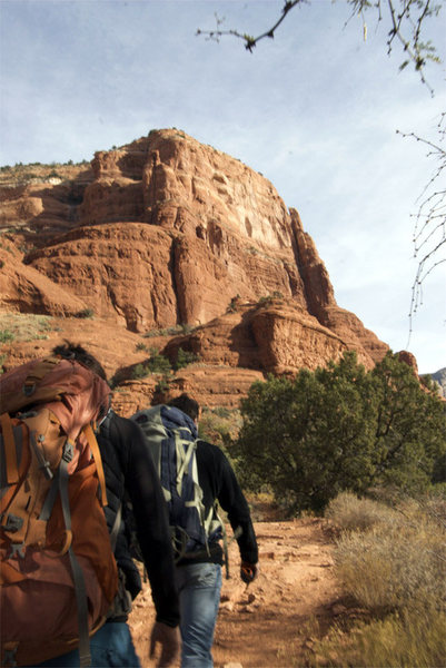 approaching Coyote Tower on Courthouse Butte. Route ascends close to right skyline finishing just shy of butte top. After passing tower on right go to edge of Butte on main tourist trail and then angle back left up slabs diagonally to start up and left a few hundred feet up the cliff wall