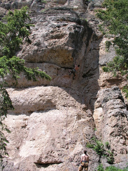 Dan Miller stares up at the cruxy part of La Babareena .11b at the Valhalla cliff in Tensleep