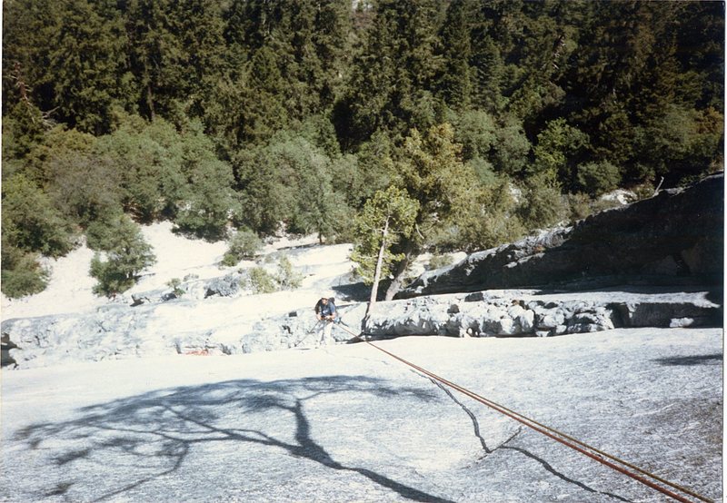 My brother Doug rapping down from the Apron with bandaged hands after about a 50 ft slide down the face. I made him suffer through belaying me up to finish the pitch and rap to retrieve my gear, to much money to leave behind.