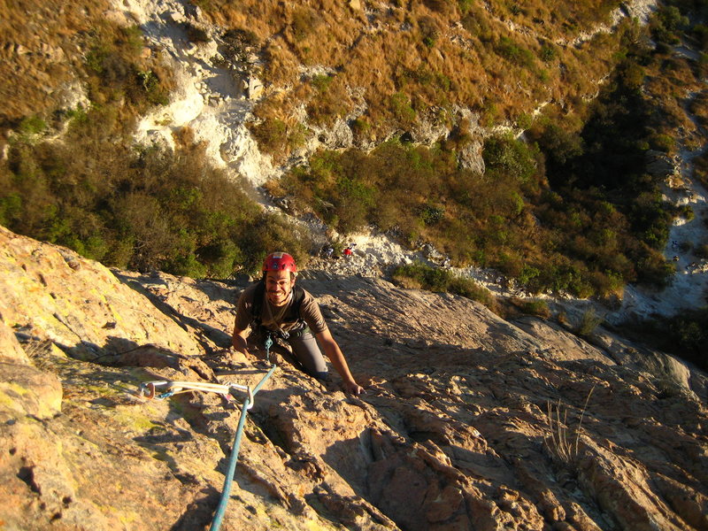 leon islas following one of the first three pitches of 'el lado oscuro de la luna' on pena de bernal.