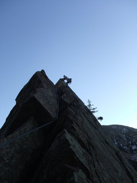 Barry making the traverse from the summit to the Dirty Deed's rappel start.