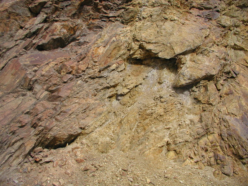 Weathering in the Colorado Mineral Belt near Boulder. These rocks have been chemically changed by the circulation of hot fluids rising up along very old faults. While hydrothermal alteration has basically destroyed these rocks from a climbing point of view, other hot-fluid alteration (Adularia:potassium feldspar) accounts for the hard sandstone of the Fountain Formation in El Dorado Canyon. See scanning electron microscope pic of this adularia, infra. Fountain Formation rocks that are not near the Colorado Mineral Belt are poorly cemented and crumbly.