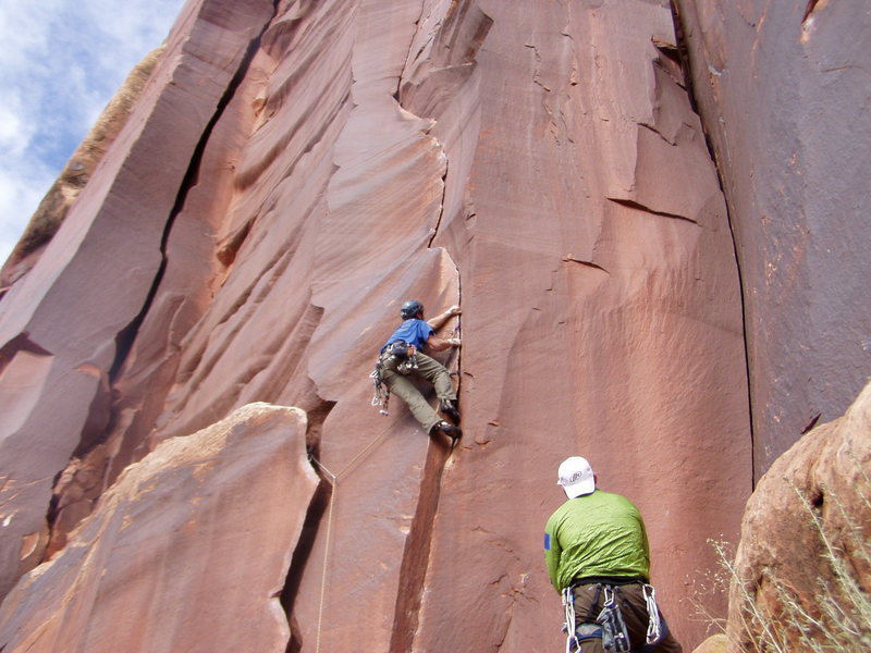 I just traversed from the wide crack to the thin crack (crux). The piece to my left is a very tipped out old #5 camalot. A #6 would have been much better. Also, you can climb straight up to this spot @ 12-.