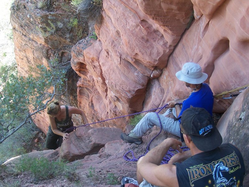Belaying hikers up short second 5th class section on Lady Mountain mountaineers' hike. Most hikers with scrambling experience can easily up- or down-climbed this section by stemming without a rope.