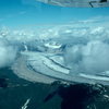 Alaska glacier, flying into Denali basecamp from Talkeetna. Colored ribbons of rock on the glacier indicate merging of several glaciers upstream.  
