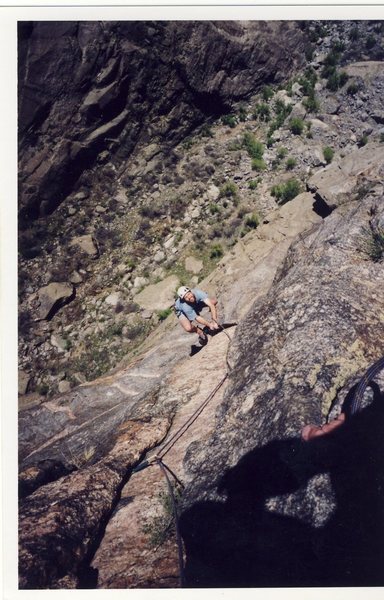 Manteling the "peg flake" on the Peg traverse. Photo by Josh Janes.