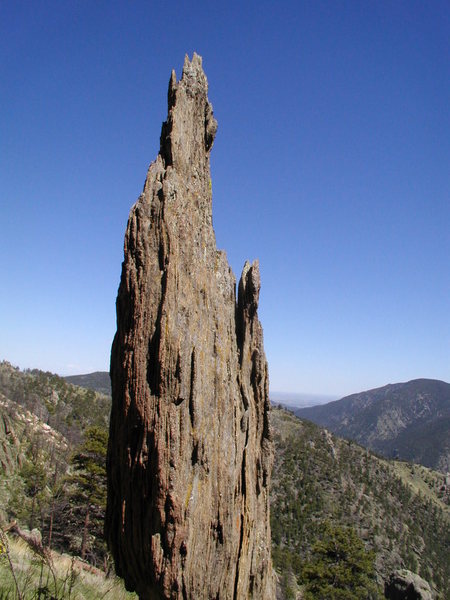 Monastery, east of Estes Park, CO. Pegmatite sill intruded into "country rock," the metamorphic basement rock of Colorado. The basement rocks and sills were later faulted into horizontal positions. Pegmatites are coarse/large grained granitic masses with large crystals of quartz, feldspar, and tourmaline.