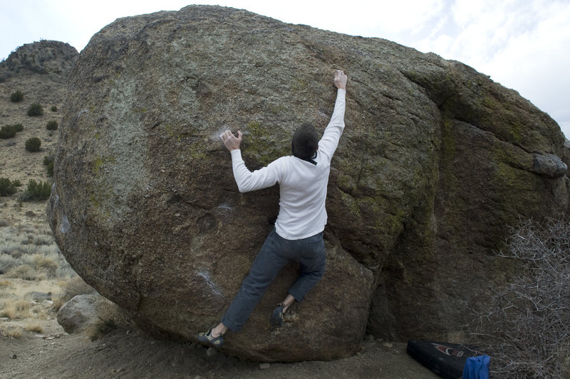 Sit start begins with hands matched on the very low chalked flake by the climber's left knee.
