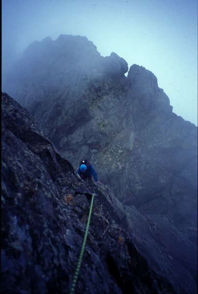 Shane Cook following the crux pitch on the Settler's NW Ridge on the first ascent in some wet weather.