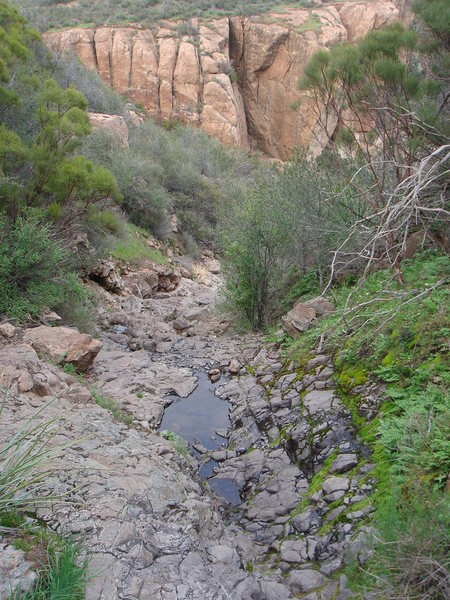 From the main trail, head down the steep gully. Will be wet after the rains.