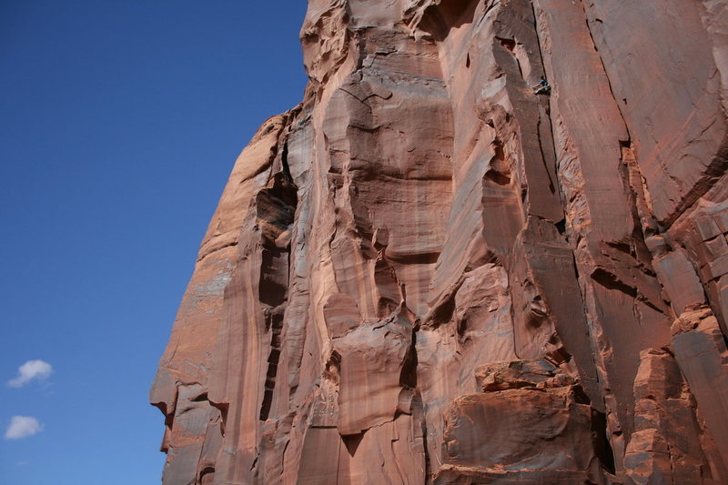 Climber nearing the anchors and about to dive into the offwidth finale.