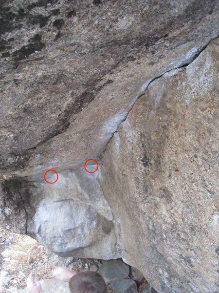 Picture of the first half of Tilt. Starting holds are small crimps (circled in red). The route proceeds up the crack on the right and then tops out over the lip(s).