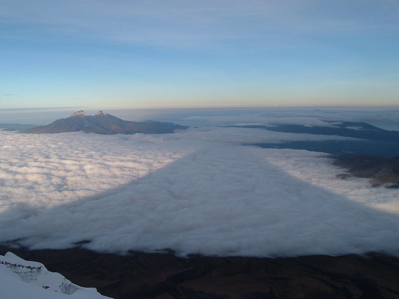 Shadow of Cotopaxi from the regular route, a very enjoyable and scenic snow climb. Illinizas in the distance.