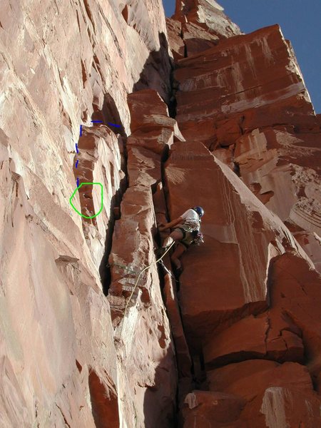 Blue line is the original Kor-Ingalls second pitch. There is one bolt on the left wall of the crack. Going this way means you get to use the cool hueco, circled in green. Pro your second for the traverse back right.